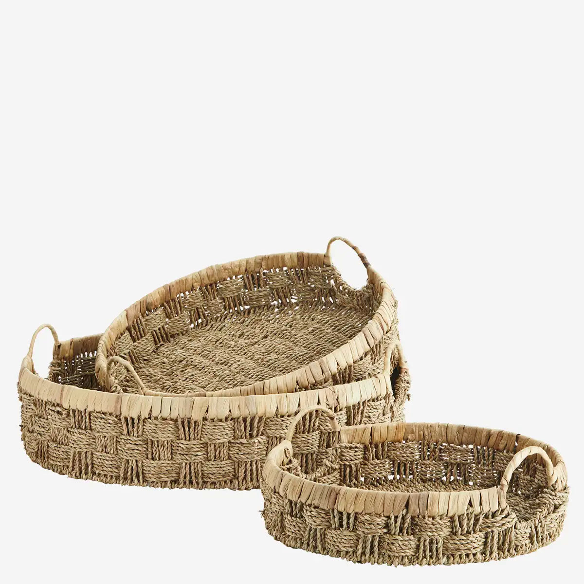 Set of three woven baskets with handles on a white background