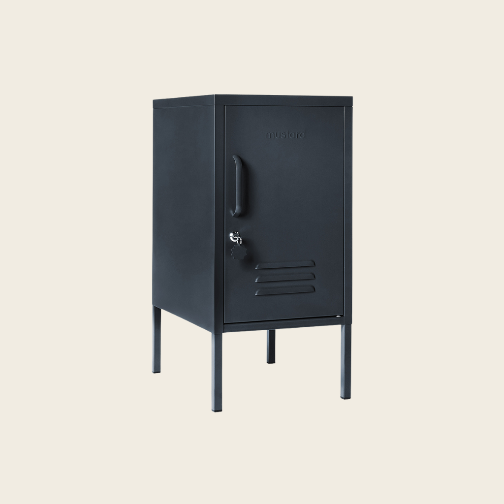 Slate metal locker with a handle on a beige background