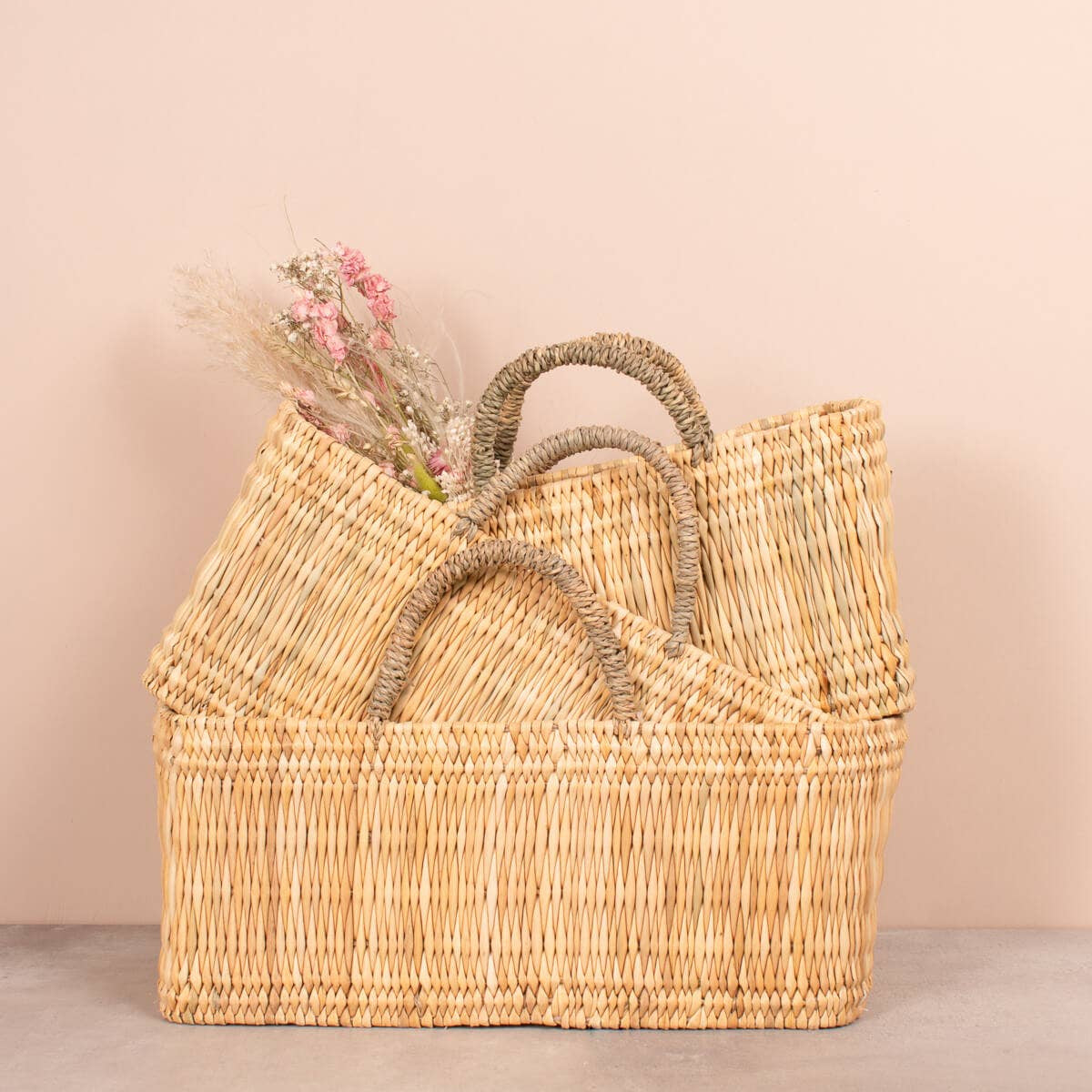 Stack of woven baskets with a beige background