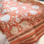 Floral patterned tablecloth on a table with a blurred background
