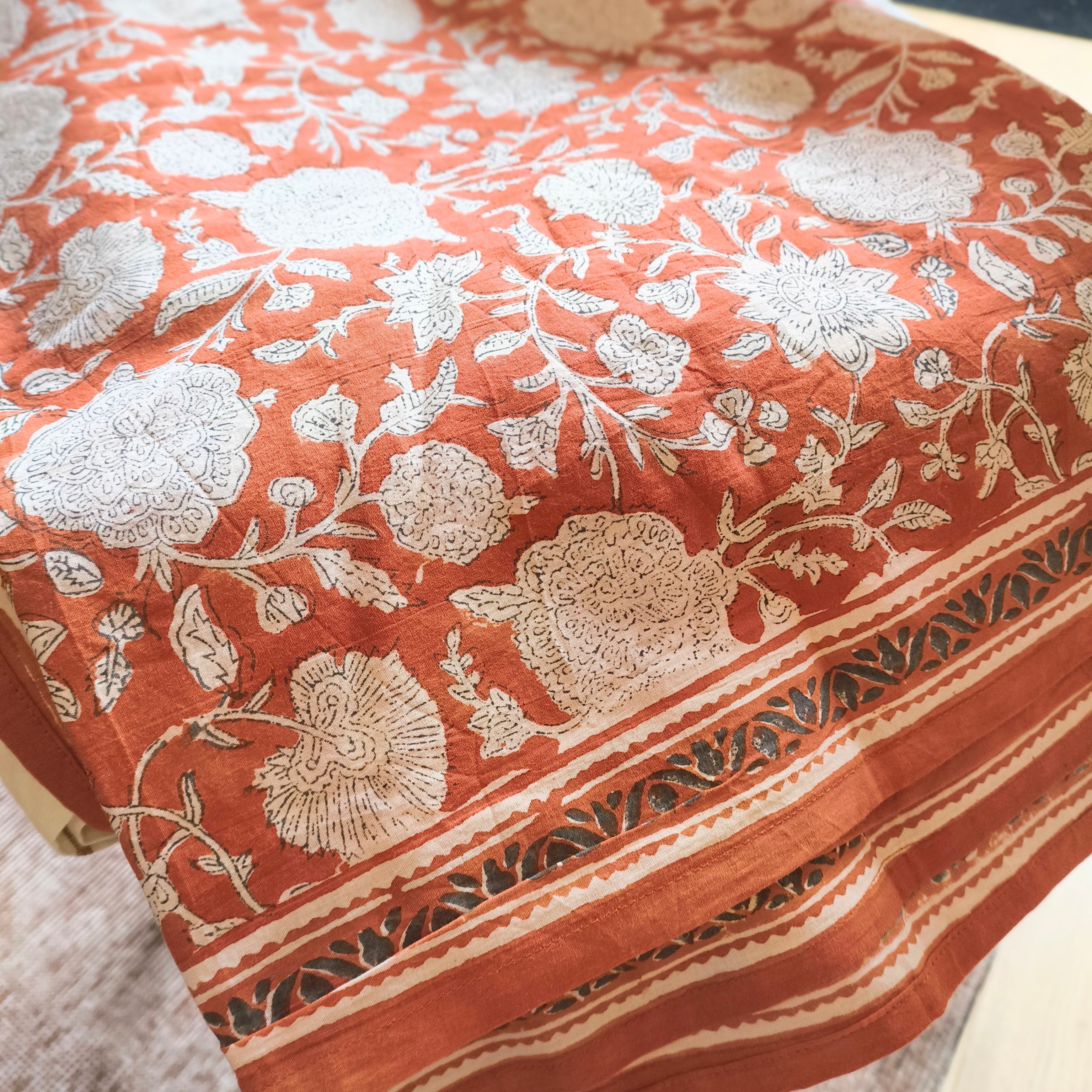 Floral patterned tablecloth on a table with a blurred background