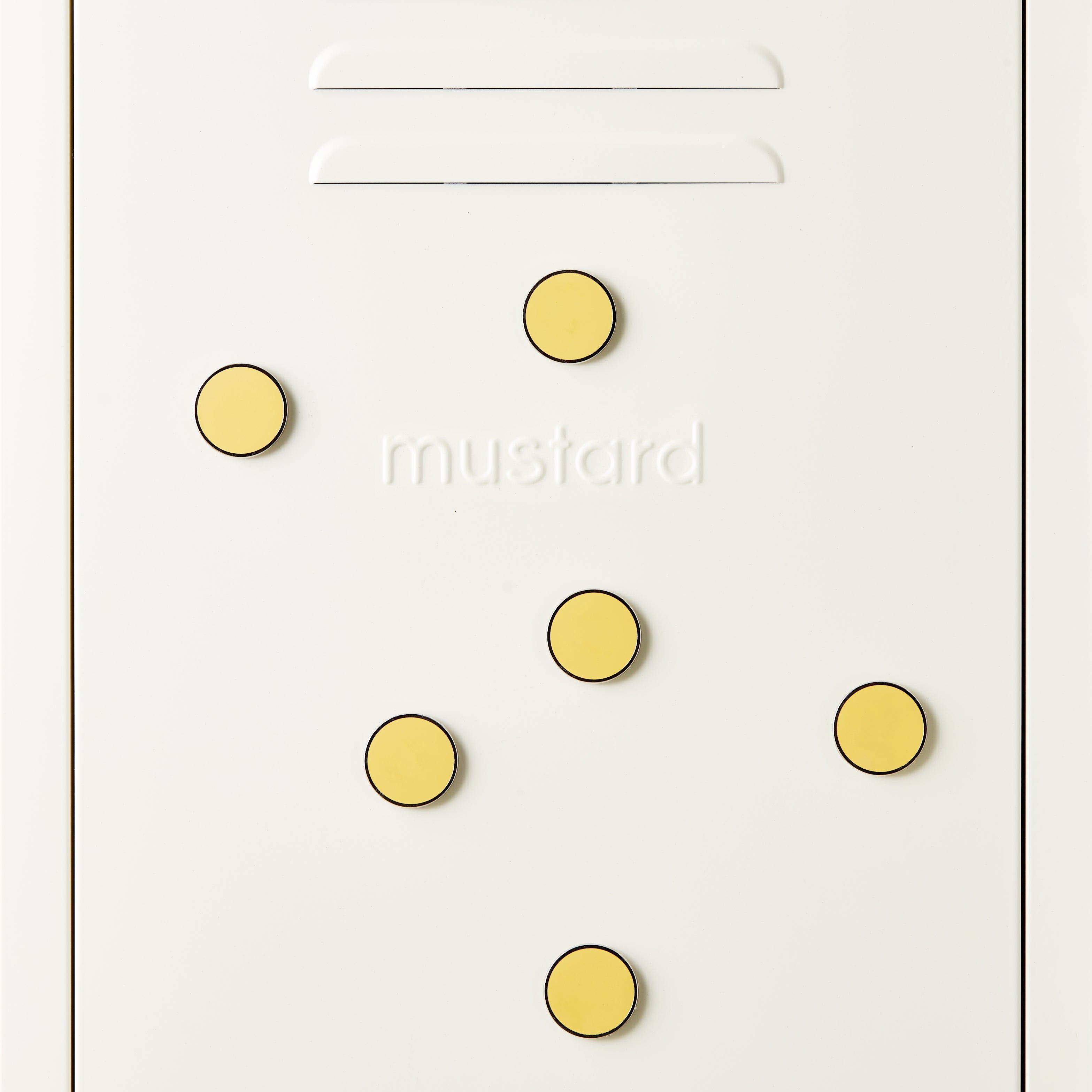 Yellow circular magnets on a white surface with 'mustard' branding.