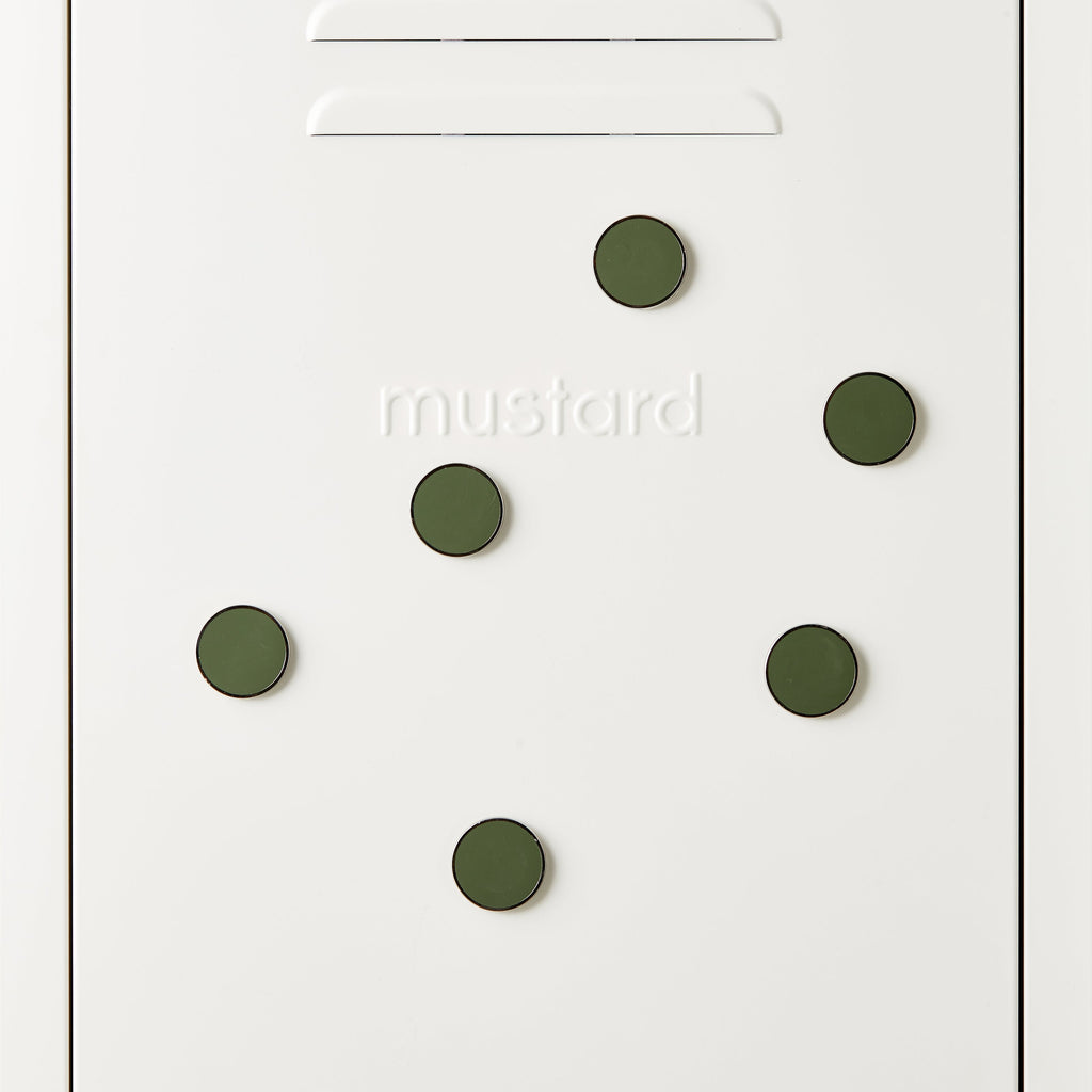 White door with green circular magnets and 'mustard' text