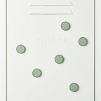 White door with green circular magnets and 'mustard' text