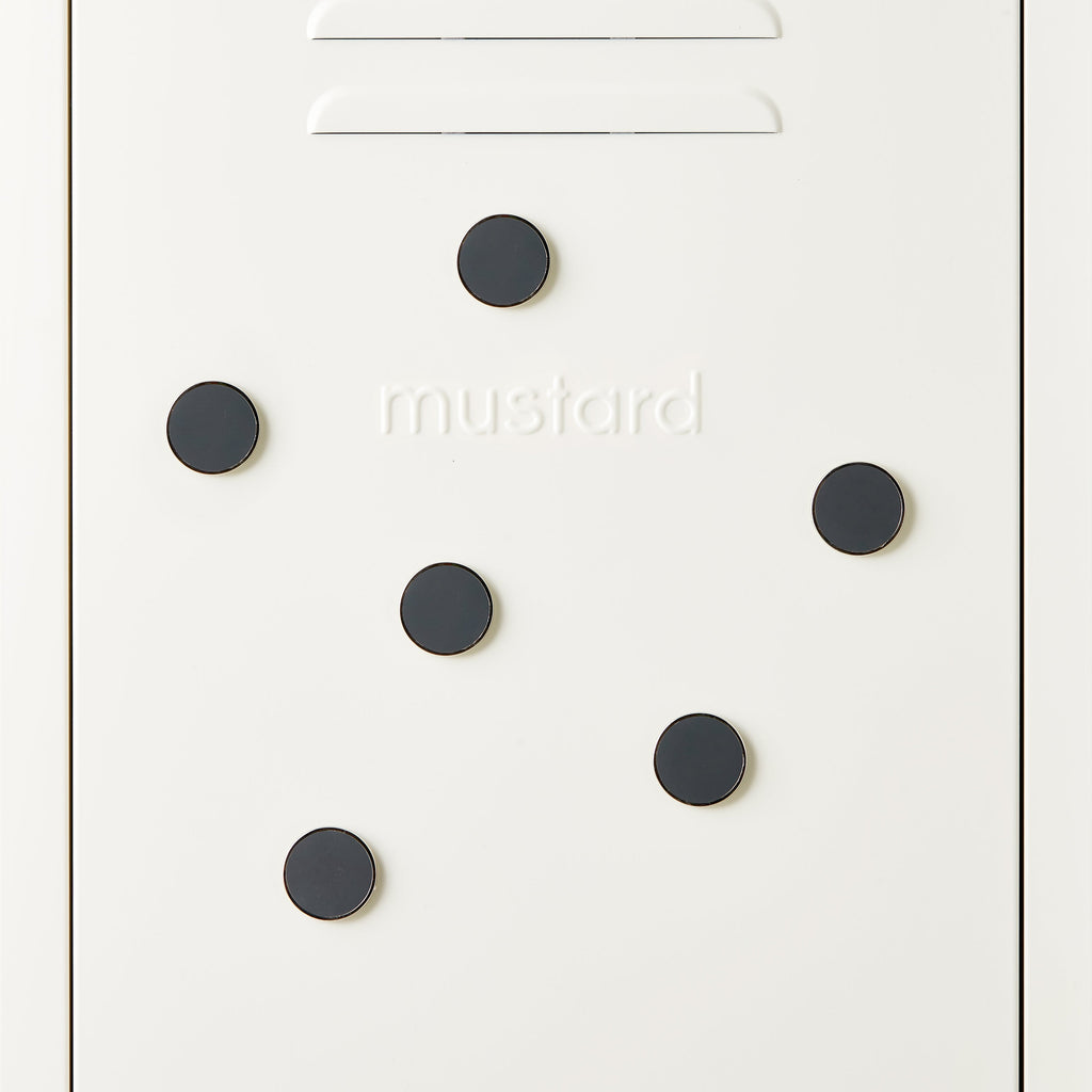 White door with black circular magnets and 'mustard' branding.