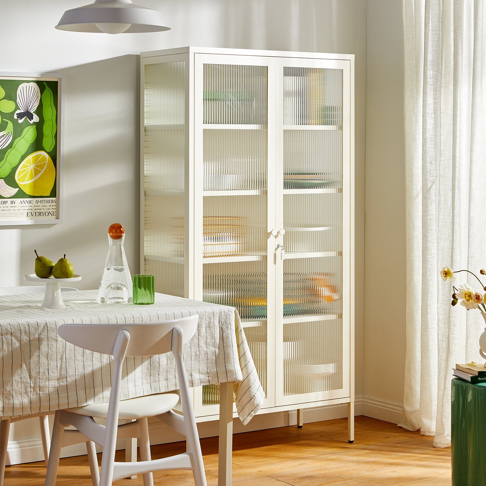 Modern kitchen with white cabinets, table, and chairs.