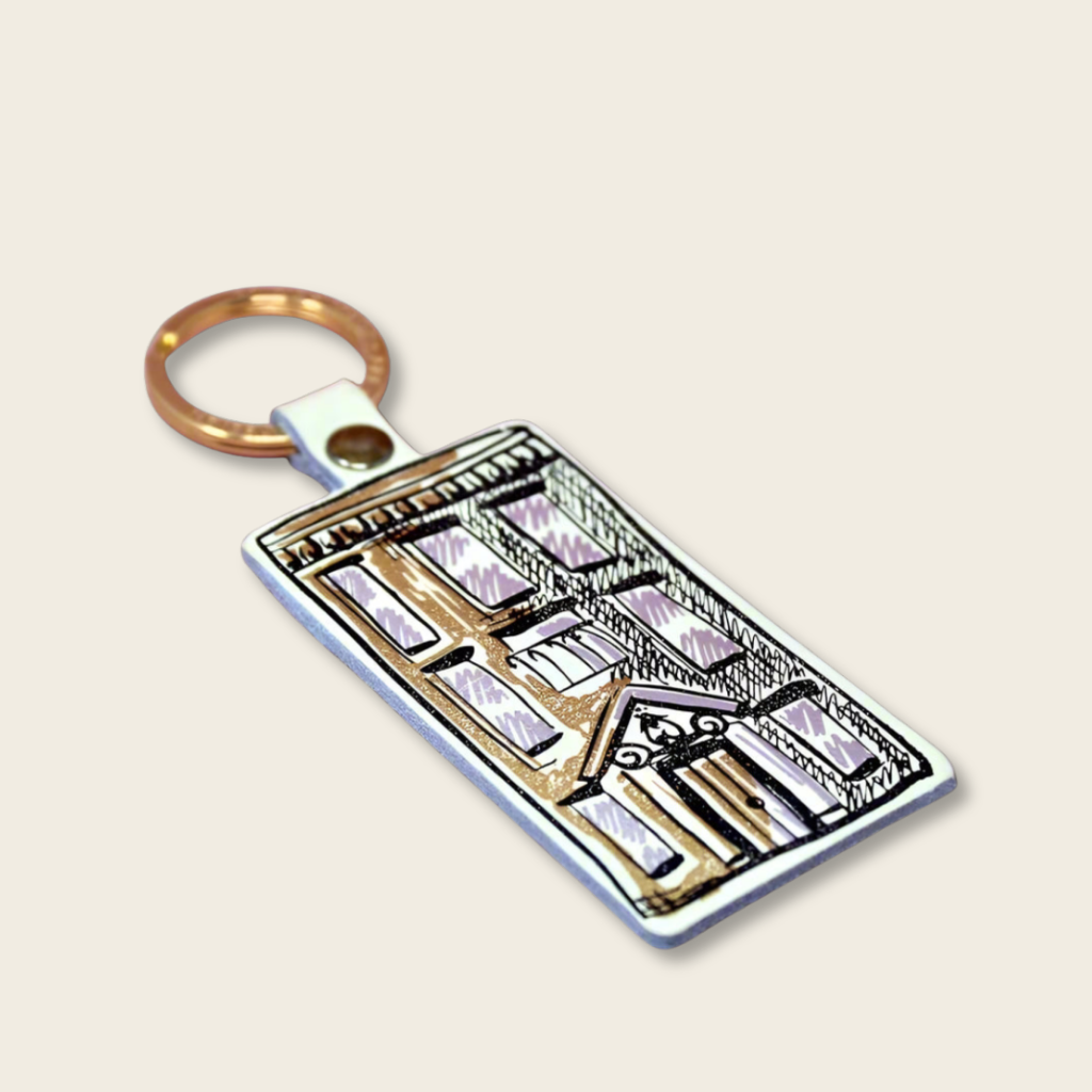 Keychain with architectural design on a beige background