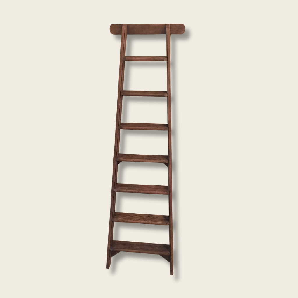 Wooden ladder on a beige background
