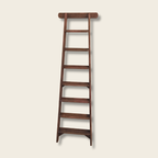Wooden ladder on a beige background