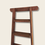 Wooden ladder on a beige background