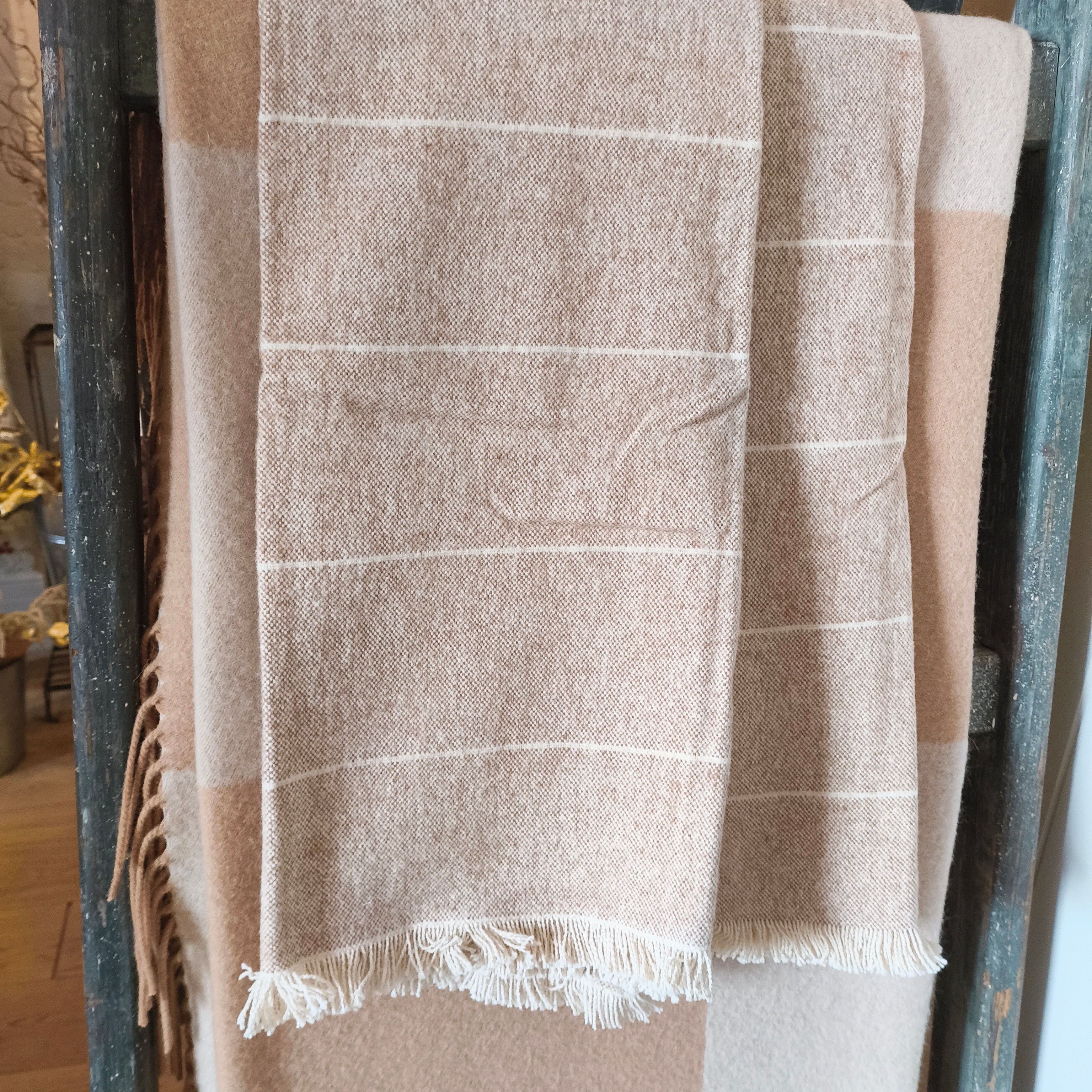 cotton clay and cream stripe throw on a rack