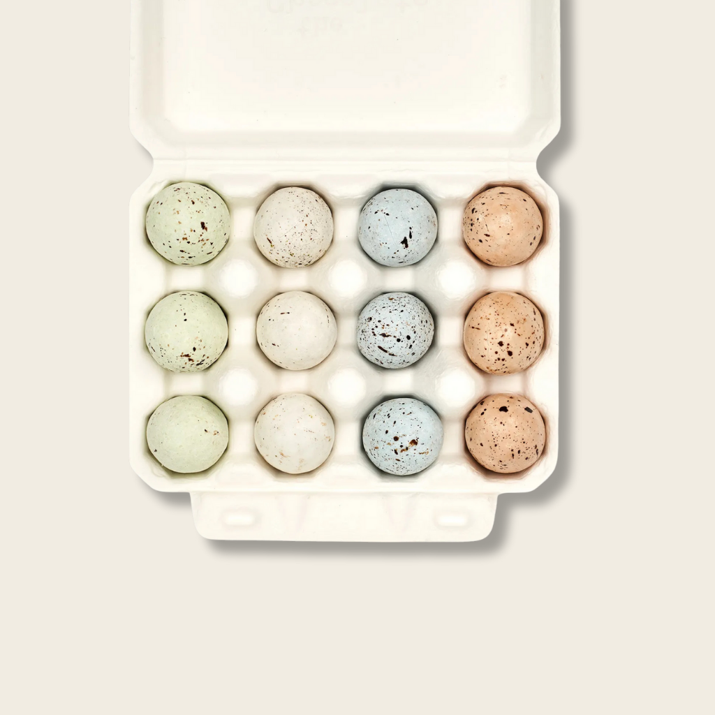 coloured speckled eggs in a carton 