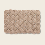 Woven Rope scallop edge door mat on a beige background