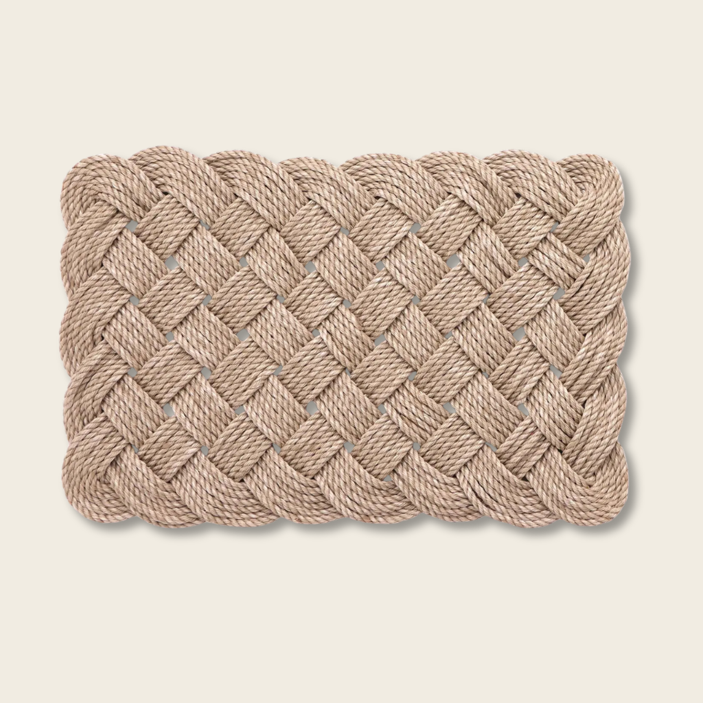 Woven Rope scallop edge door mat on a beige background