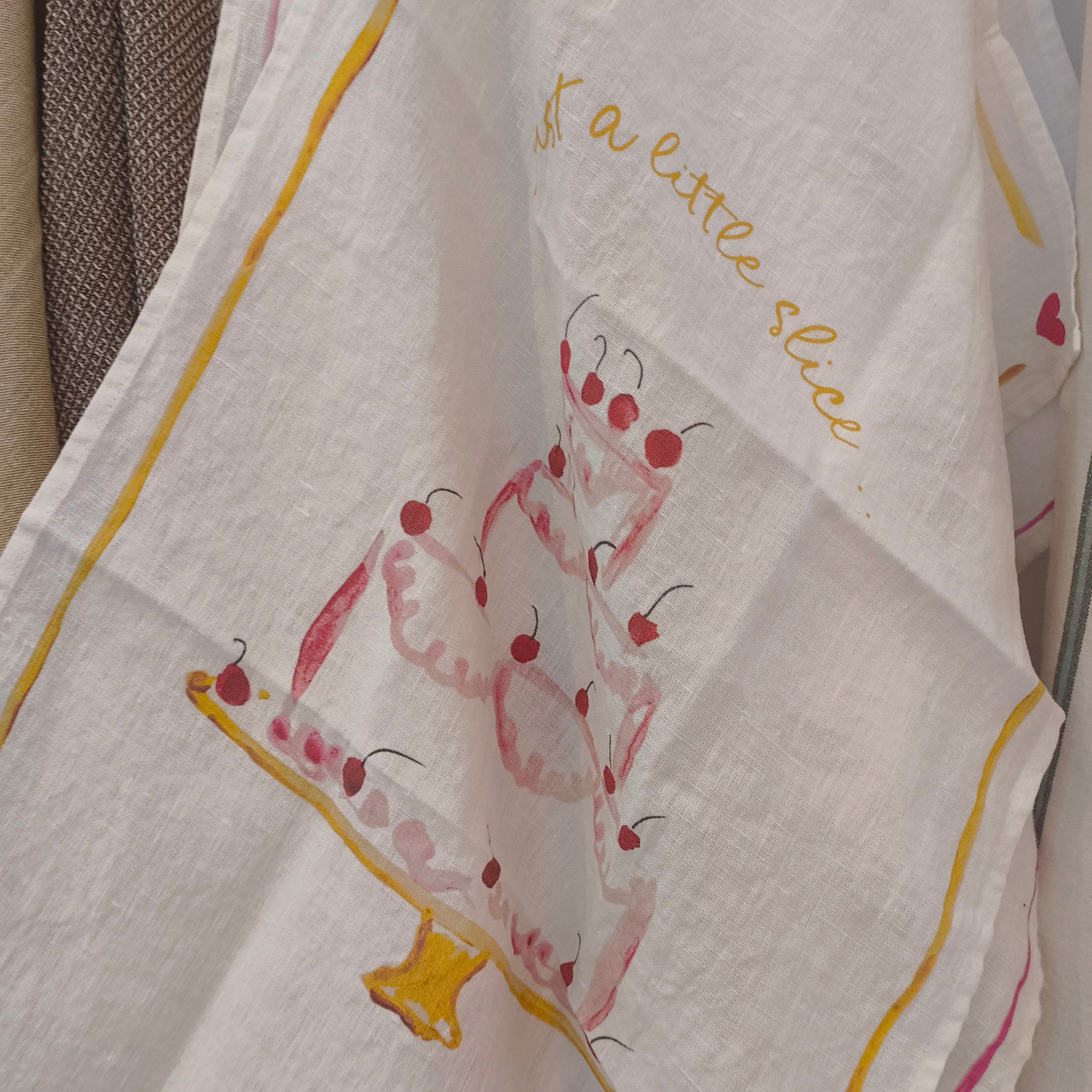 Decorative towel with a cartoon dog design and text on a rack.