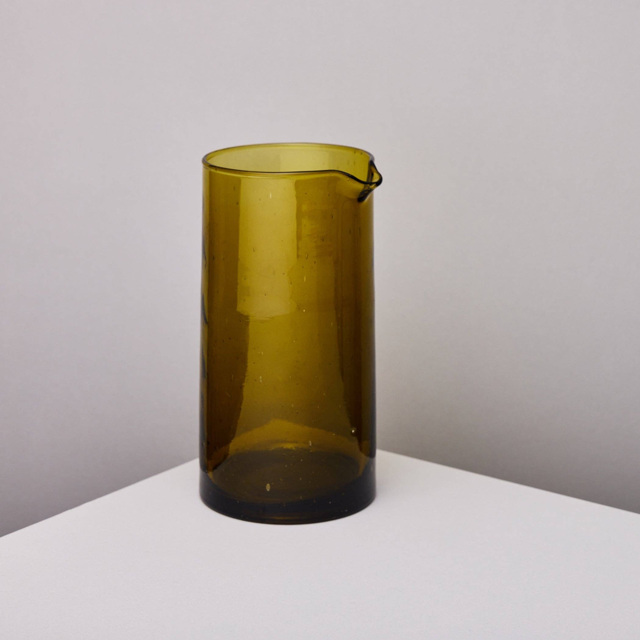 Amber recycled glass carafe with a golden olive tone