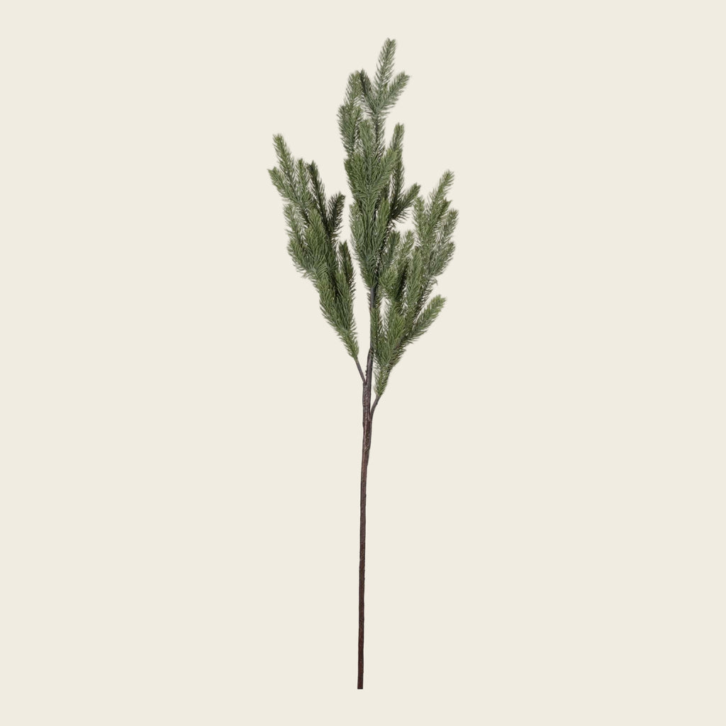 Artificial pine branch on a white background