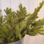 Artifcial pine stem in a metal bucket