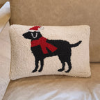 Decorative pillow with a black dog wearing a red scarf on a beige couch.