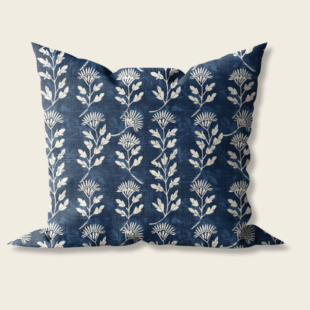 Decorative pillow with white floral pattern on a blue background