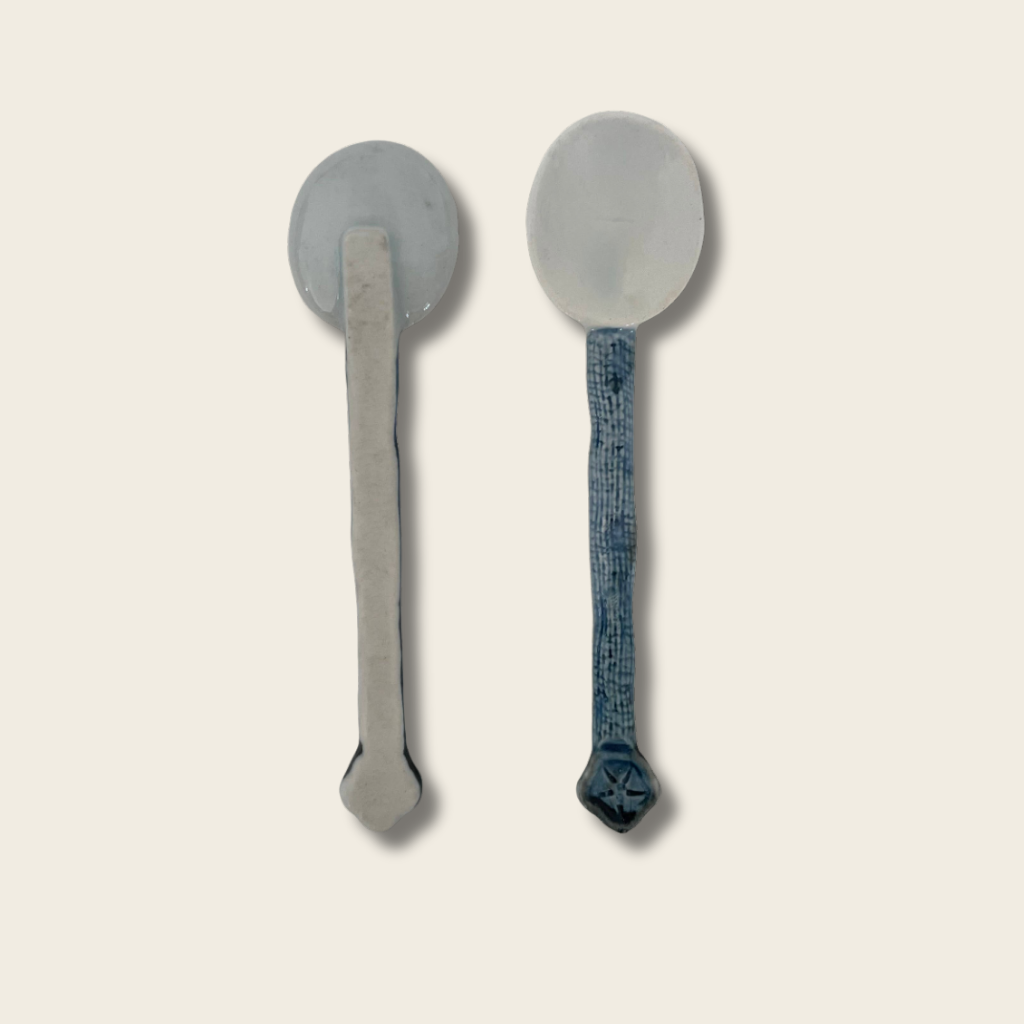 front and back view of a blue and white ceramic spoon