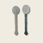 front and back view of a blue and white ceramic spoon