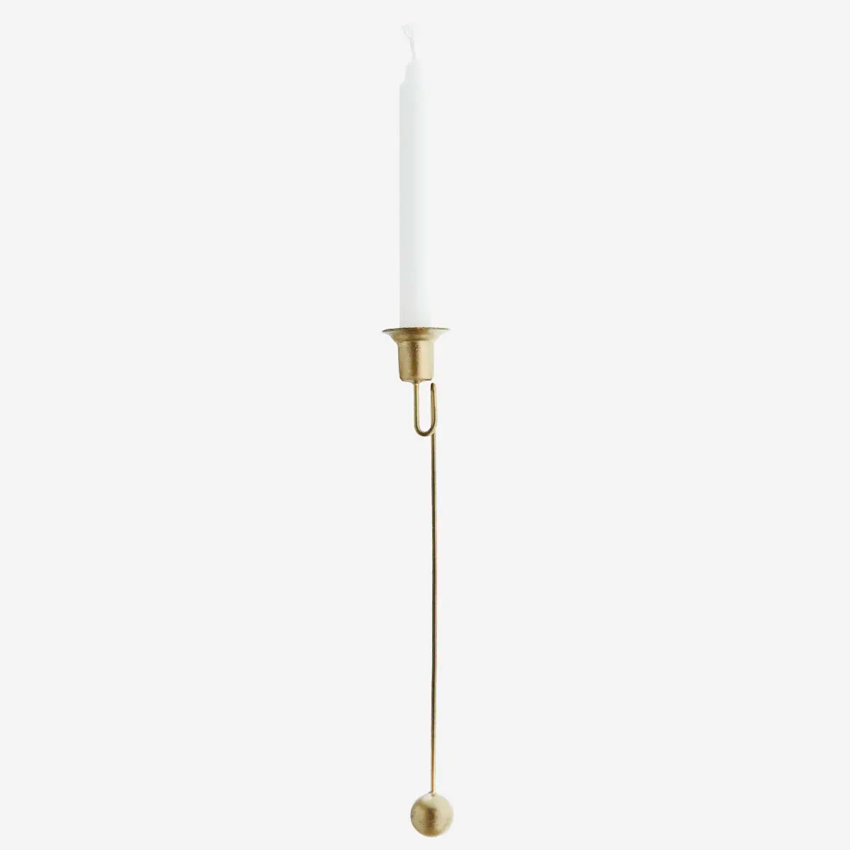 Gold candle holder with a white candle on a white background