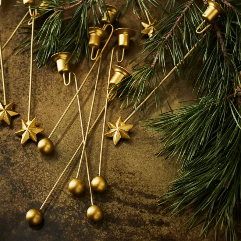 Gold jingle bells with star decorations on a rustic background