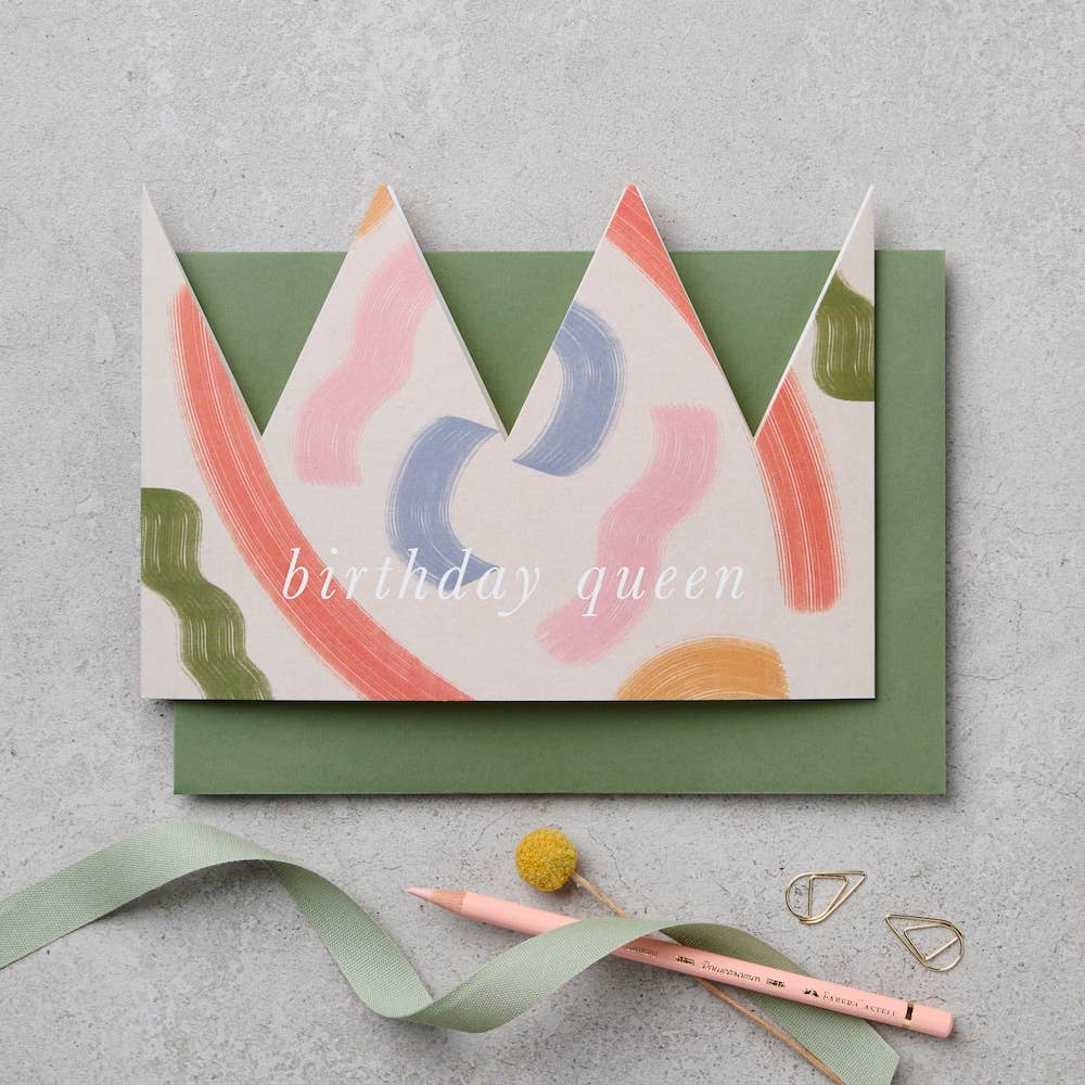 Brushstroke paper crown birthday card shown worn as a crown