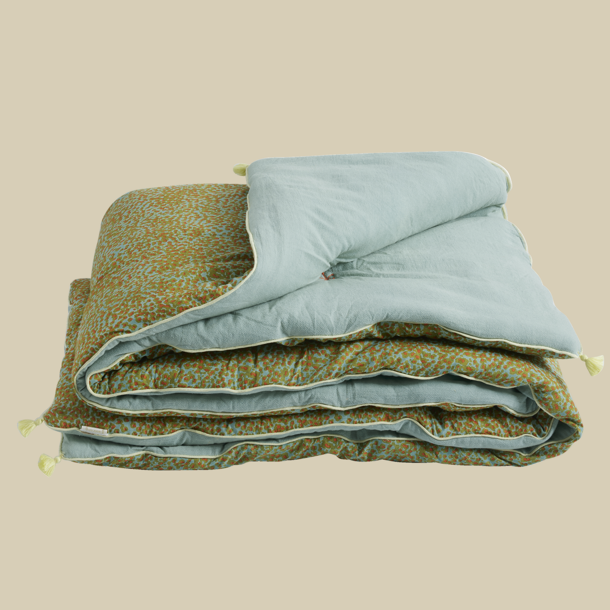 Sofa cover with one green patterned side and one light green.