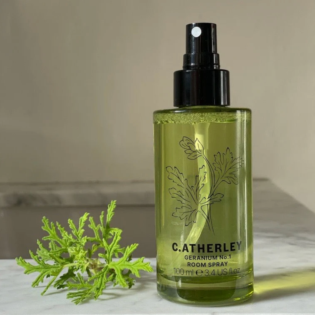 C atherley geranium room spray bottle with green leaf design on a neutral background