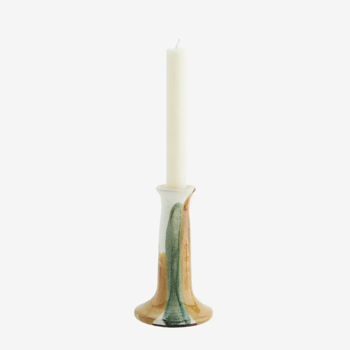 Candle in a decorative ceramic holder on a white background
