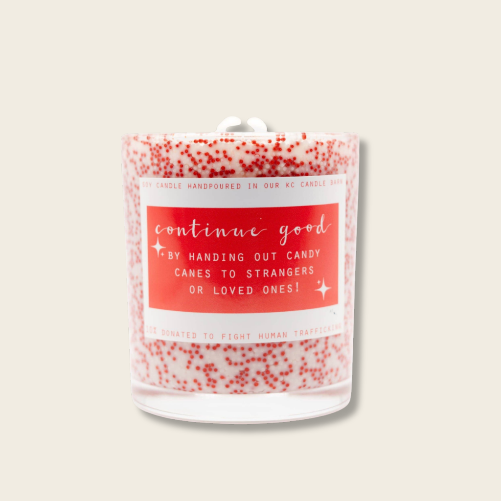 Candle with a red label and decorative pattern on a white background