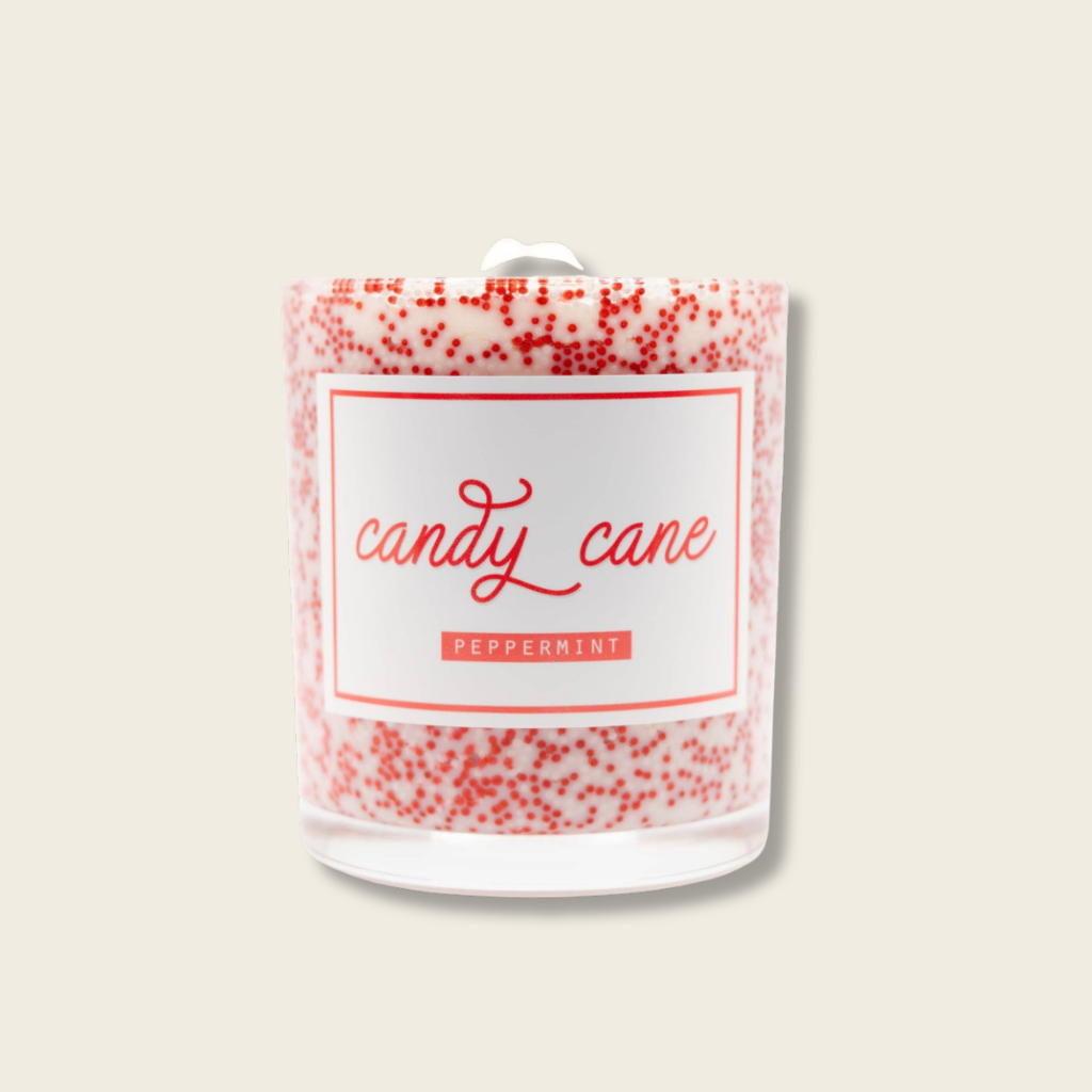 red and white cancdle with red dots saying candy cane 