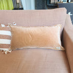 Dusk pink sofa with decorative pillows in a store setting