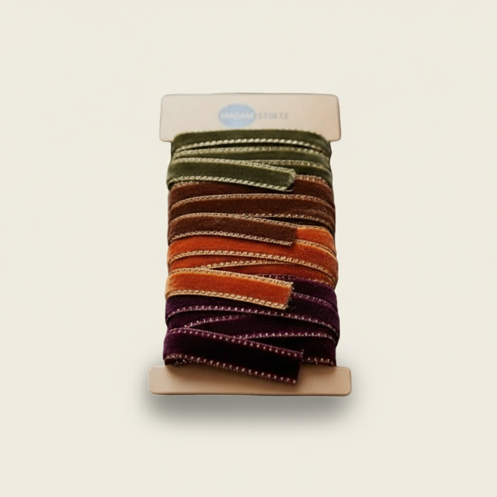 Set of colorful scrunchies on a display card with 'MADAM STOLTZ' branding.