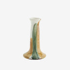 Cylindrical ceramic candle holder with gradient color from white to brown on a white background