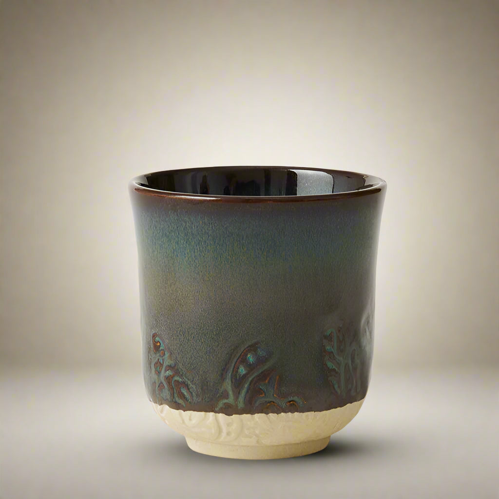 Ceramic cup with decorative patterns on a white background