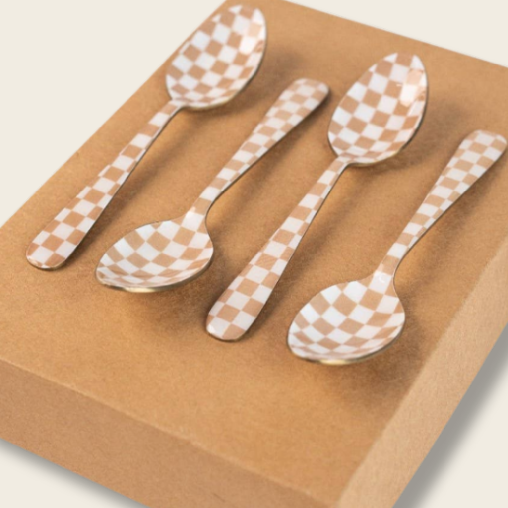 Set of four checkered spoons on a brown surface