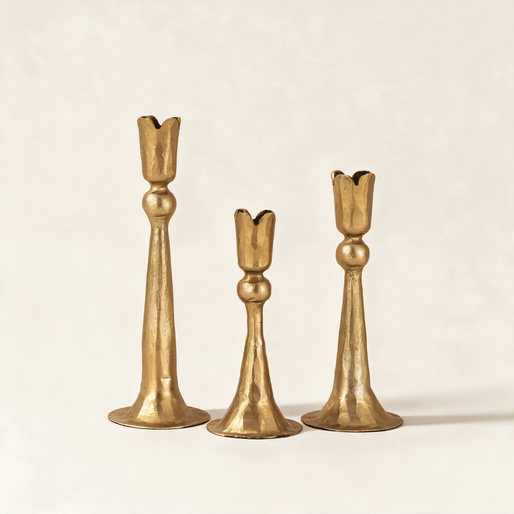 Set of three hand-forged taper candle holders in matt bright bronze, in graduated heights