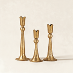 Set of three hand-forged taper candle holders in matt bright bronze, in graduated heights