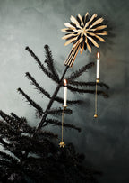 Brass Christmas tree candle holder styled with a lit candle