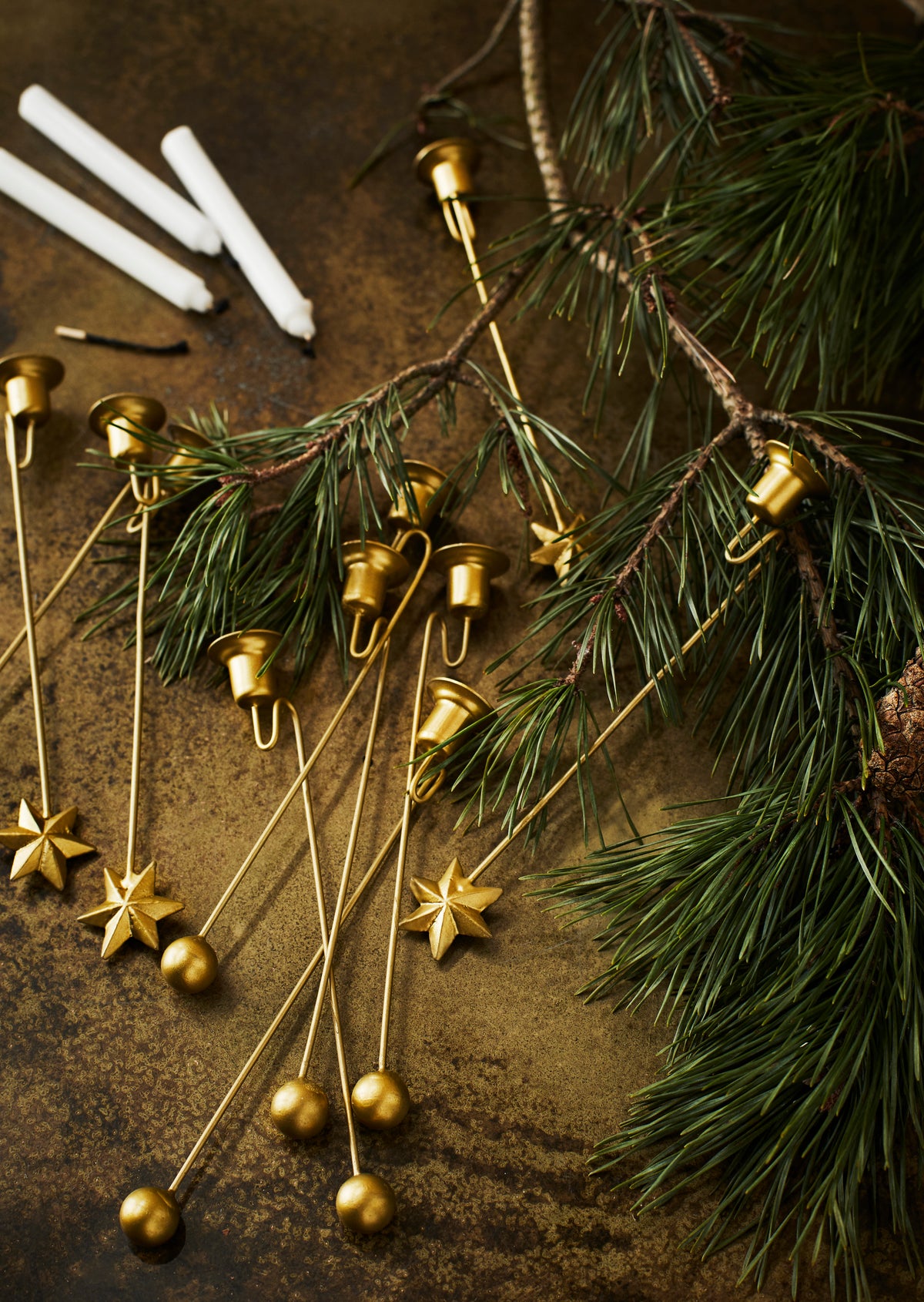 Antique brass Christmas tree candle holders in a festive table setting