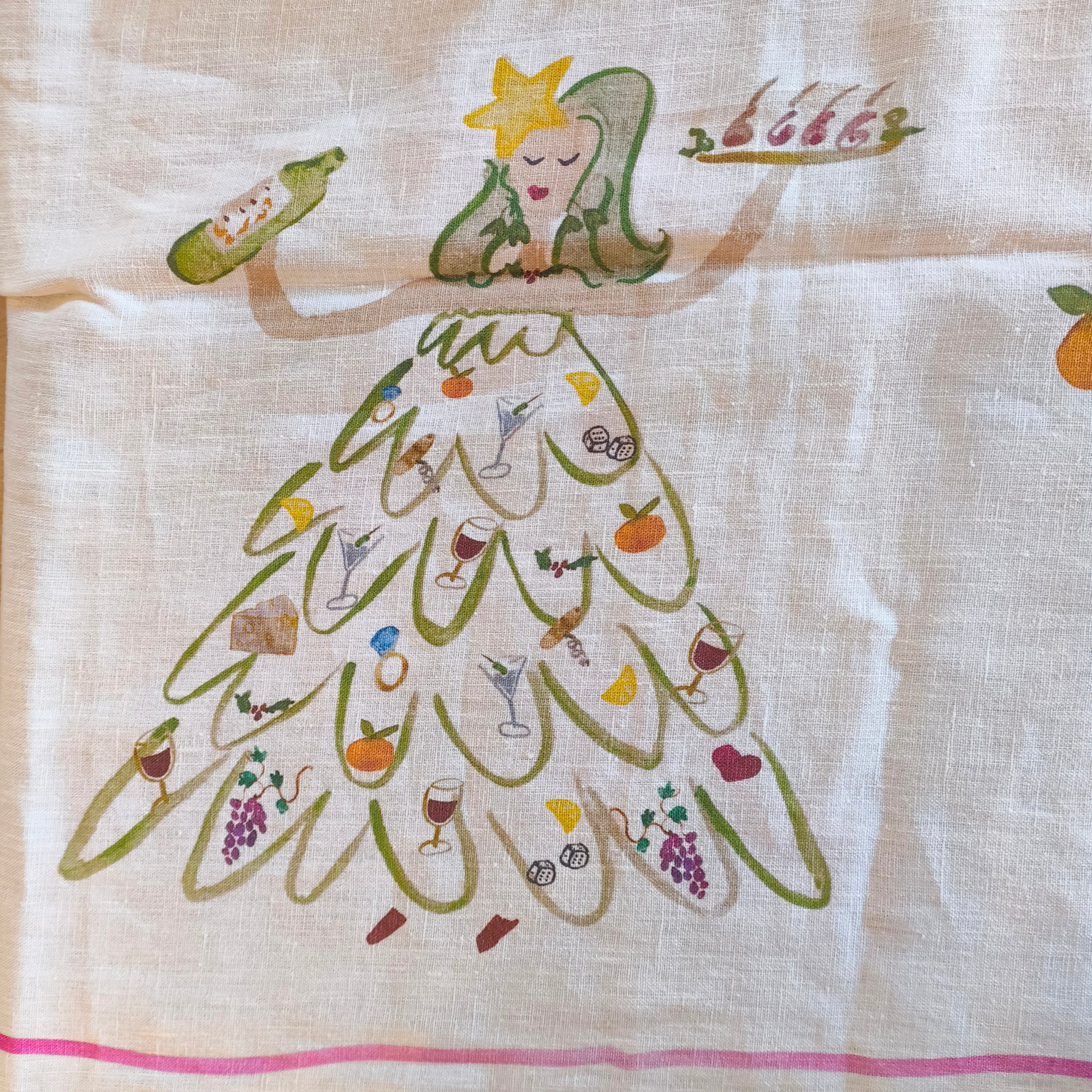 Decorative table cloth with a cartoon character in a dress made of food items on a wooden surface.