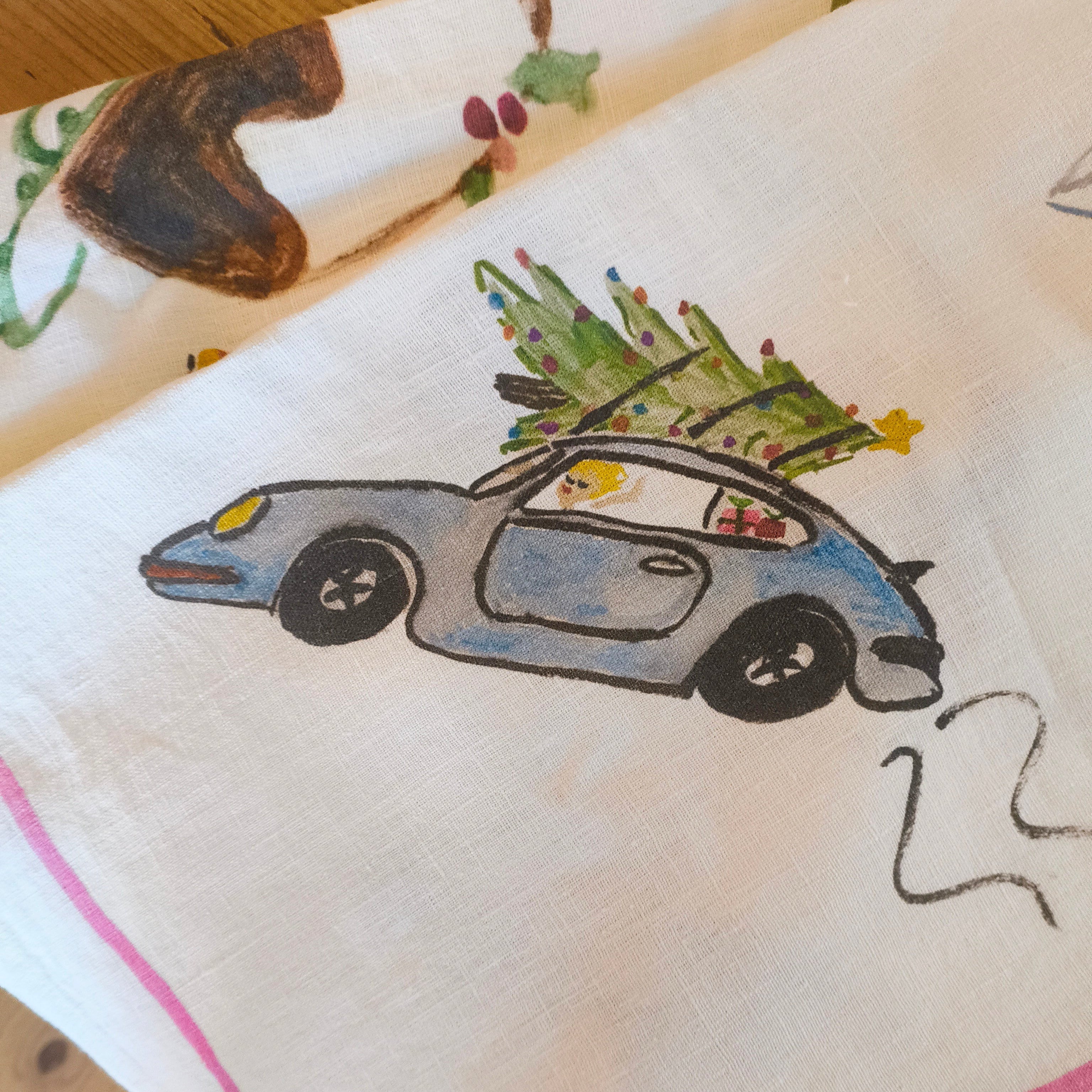print of car with trree on roof on linen table cloth