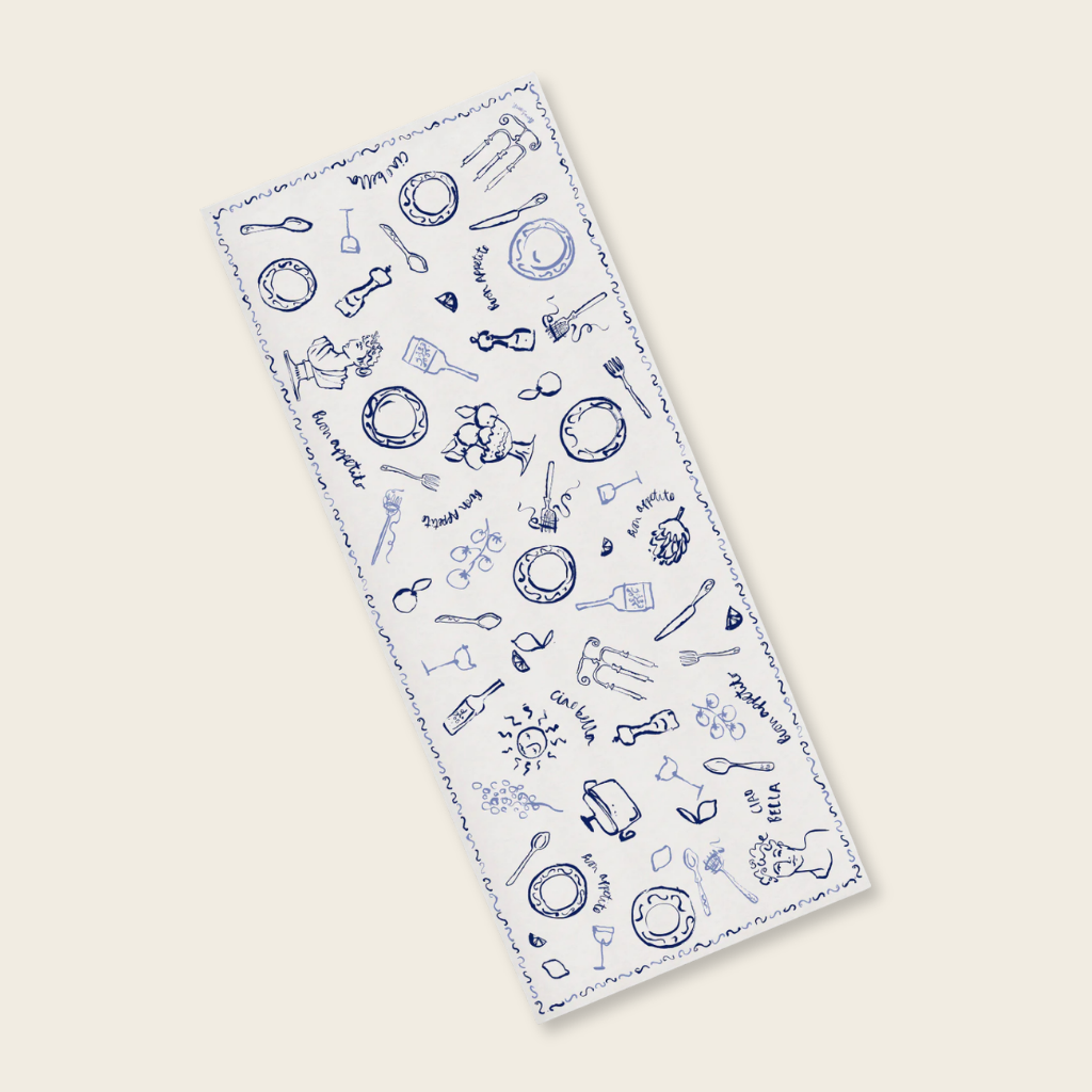 Patterned table cloth with blue designs on a white background