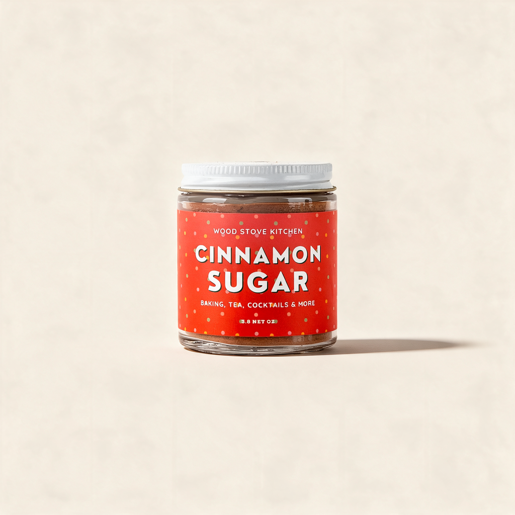 Cinnamon sugar in a clear glass jar with a white lid on a warm cream background