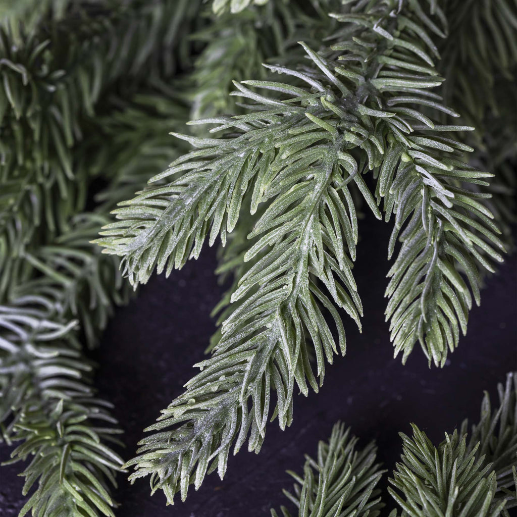 Close-up of artificial greenery with a dark background