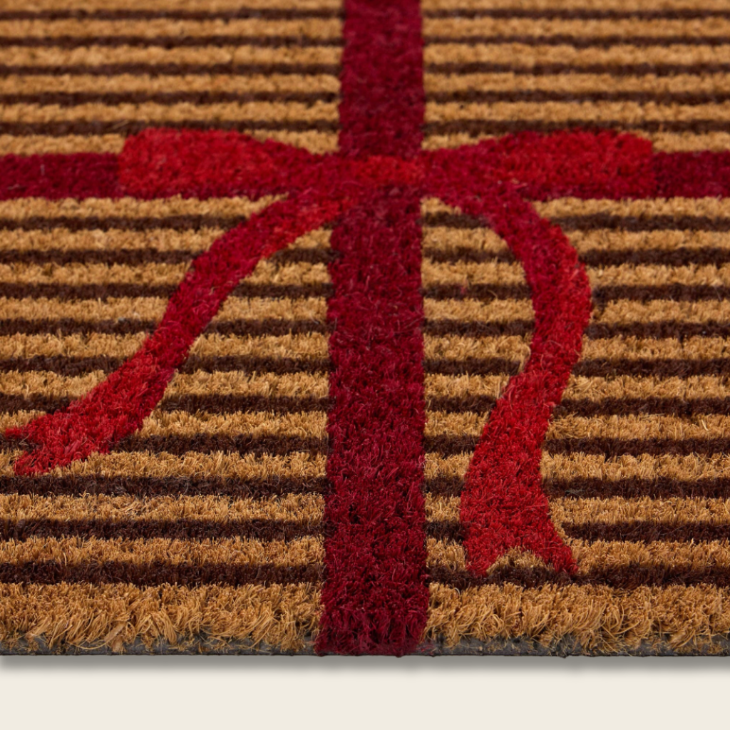 Doormat with a red 'X' on a brown and beige striped background