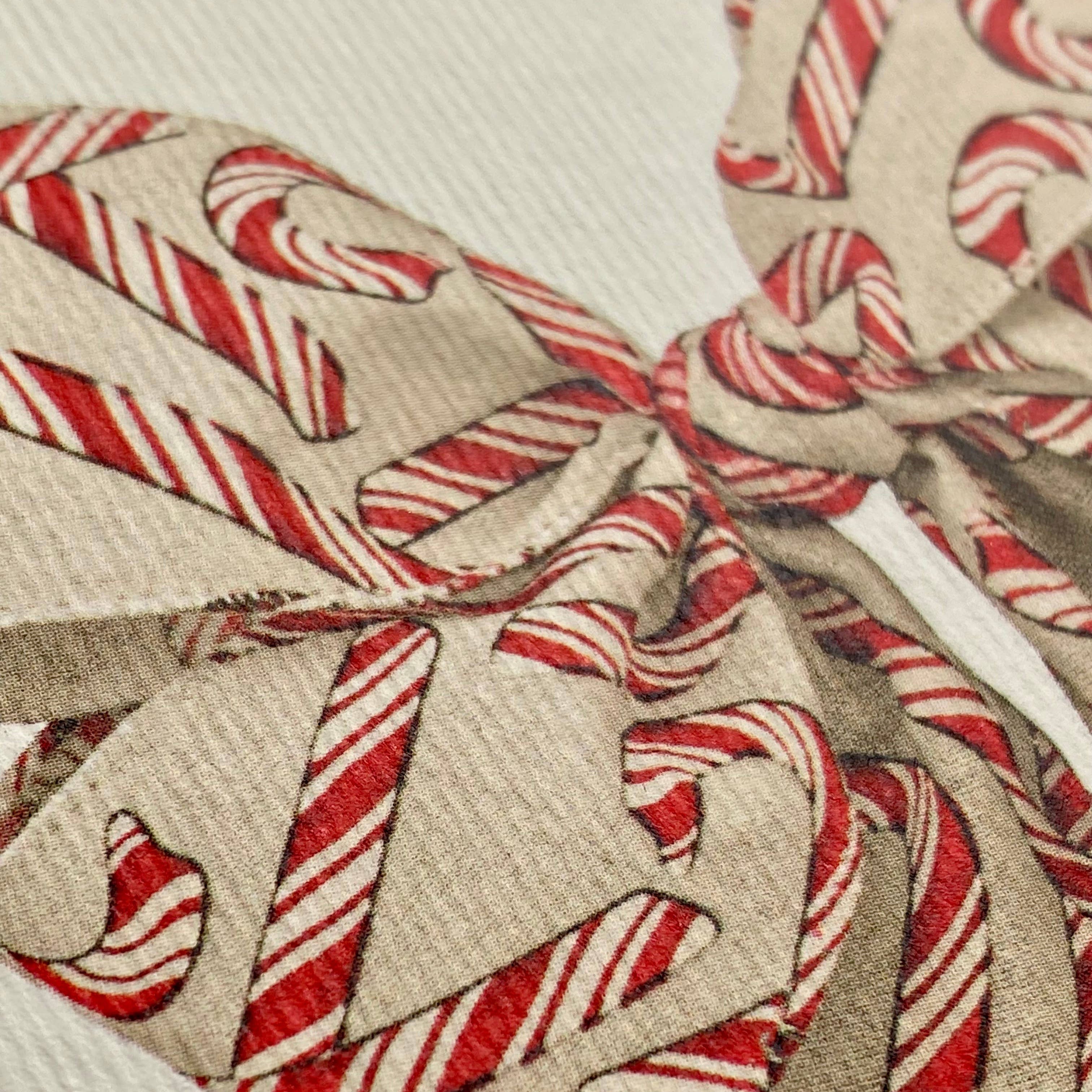Close-up of a fabric with candy cane pattern on a beige background